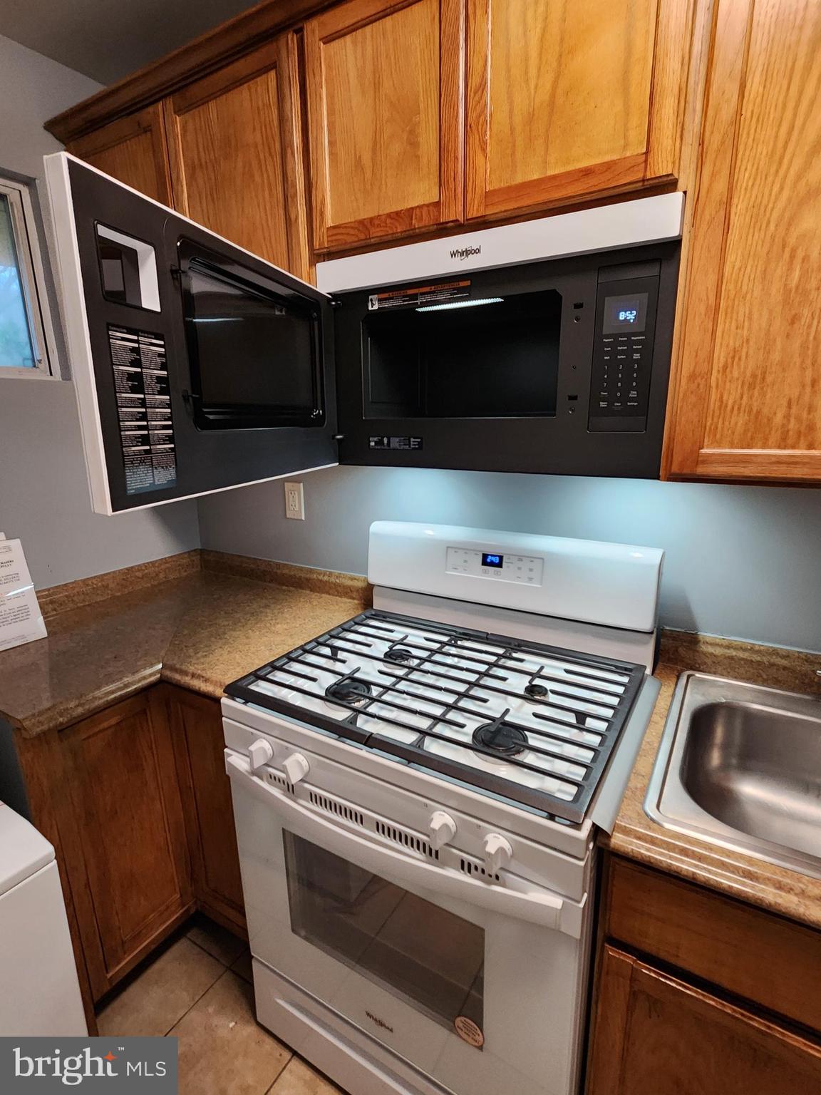 7533 Greenleaf Road Landover, MD 20785 - Photo 32 of 36 a kitchen with a stove microwave and sink