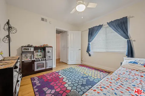 a bedroom with furniture and a window