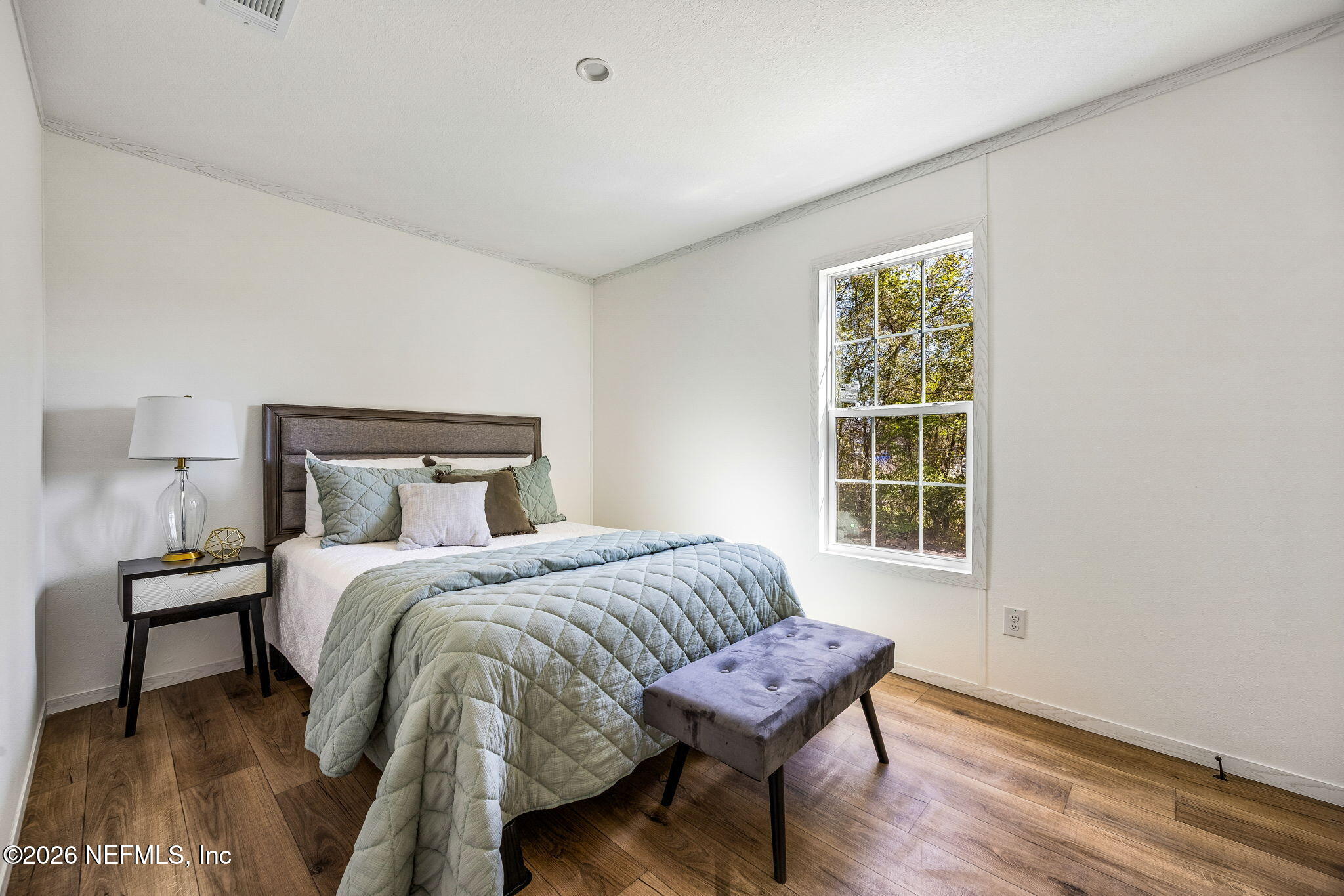 27450 West 3rd Avenue Hilliard, FL 32046 - Photo 19 of 24 a bedroom with a bed and wooden floor