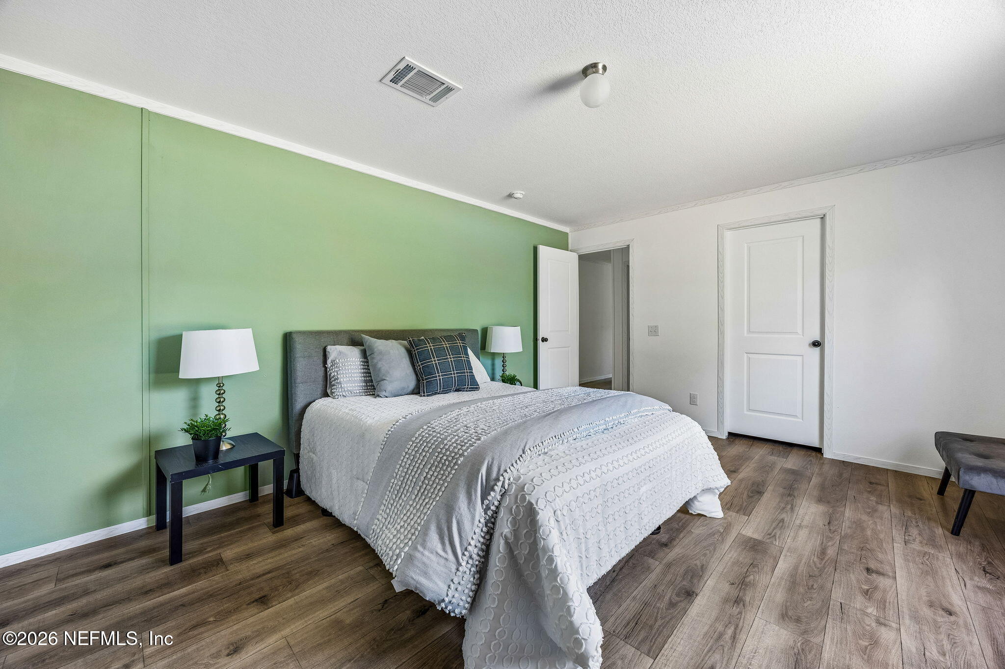 27450 West 3rd Avenue Hilliard, FL 32046 - Photo 10 of 24 a spacious bedroom with a bed and a table