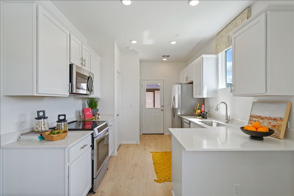 2534 Caleb Asher Loop Round Rock, TX 78665 - Photo 10 of 40 a kitchen with stainless steel appliances granite countertop a sink stove and cabinets