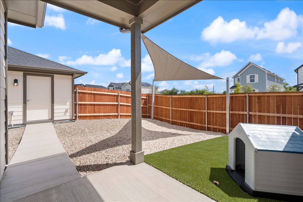 2534 Caleb Asher Loop Round Rock, TX 78665 - Photo 14 of 40 a view of a backyard with couches floor to ceiling window and potted plants