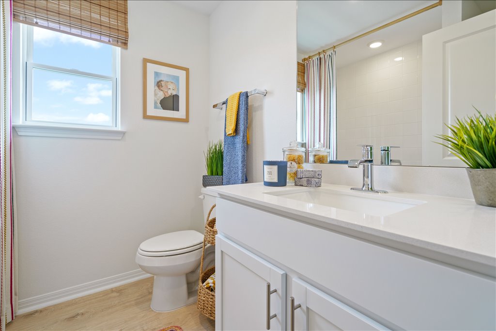 2534 Caleb Asher Loop Round Rock, TX 78665 - Photo 25 of 40 a bathroom with a sink a toilet and mirror