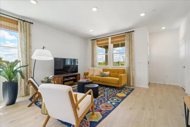 a spacious bedroom with a bed and a lamp