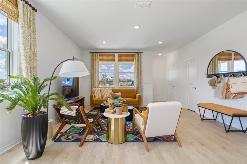 2534 Caleb Asher Loop Round Rock, TX 78665 - Photo 7 of 40 a dining room with furniture potted plants and wooden floor
