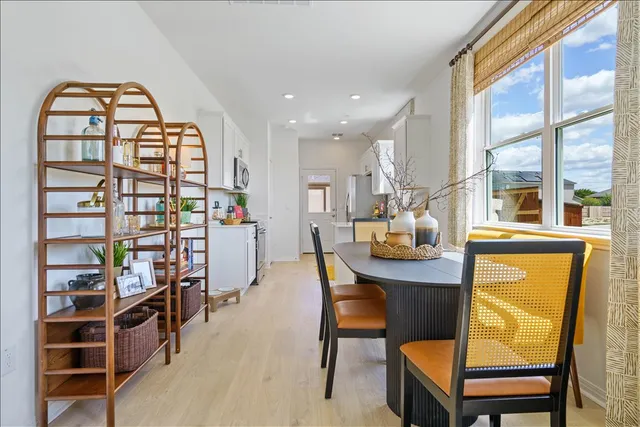 a dining room with furniture and a floor to ceiling window