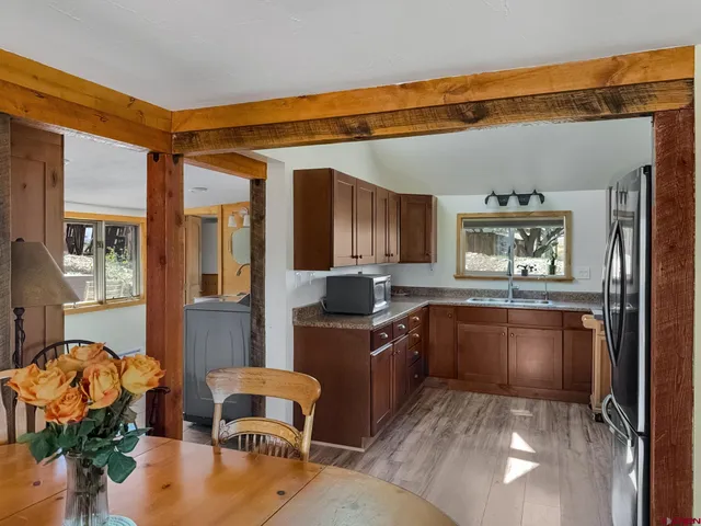a kitchen with a refrigerator and a sink