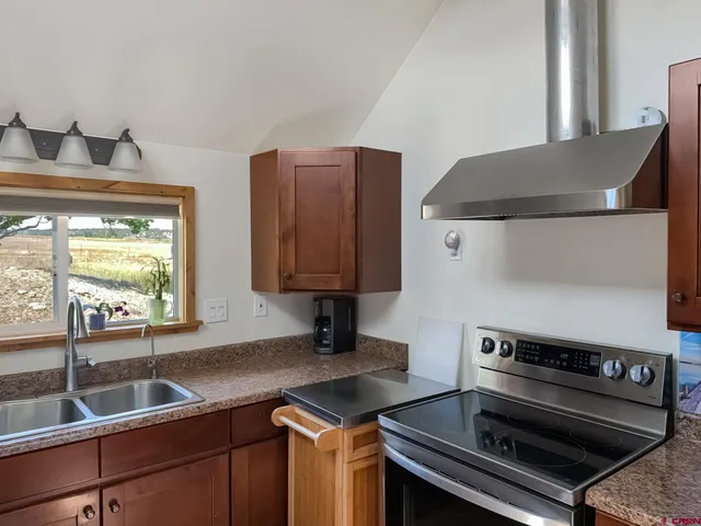 a kitchen that has a sink and a stove