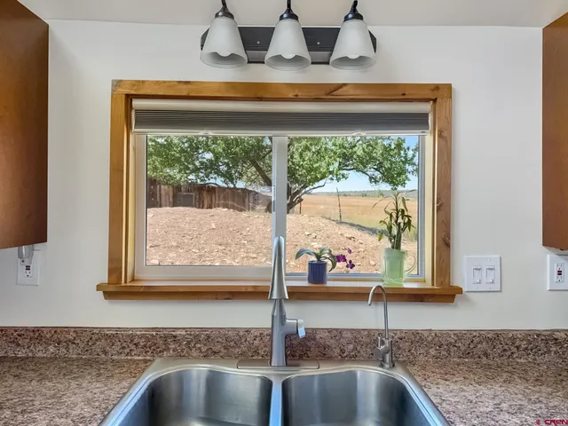 a kitchen with a sink and a window