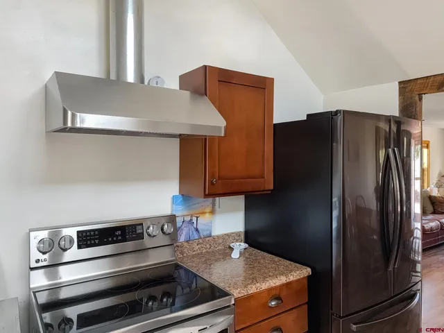 a kitchen with granite countertop stainless steel appliances and wooden cabinets
