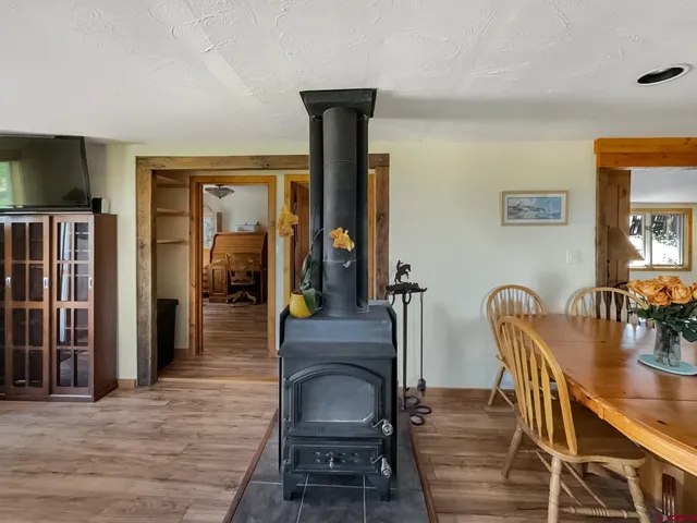 a dining room with furniture and wooden floor