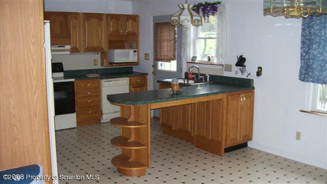2275 Booth Road Hallstead, PA 18822 - Photo 5 of 10 a kitchen with a sink and cabinets