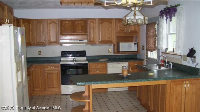 2275 Booth Road Hallstead, PA 18822 - Photo 6 of 10 a kitchen with a refrigerator and a sink
