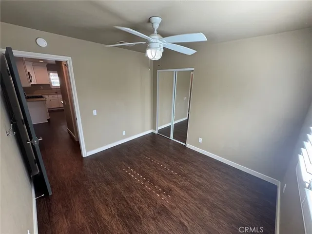 wooden floor in an empty room with a mirror