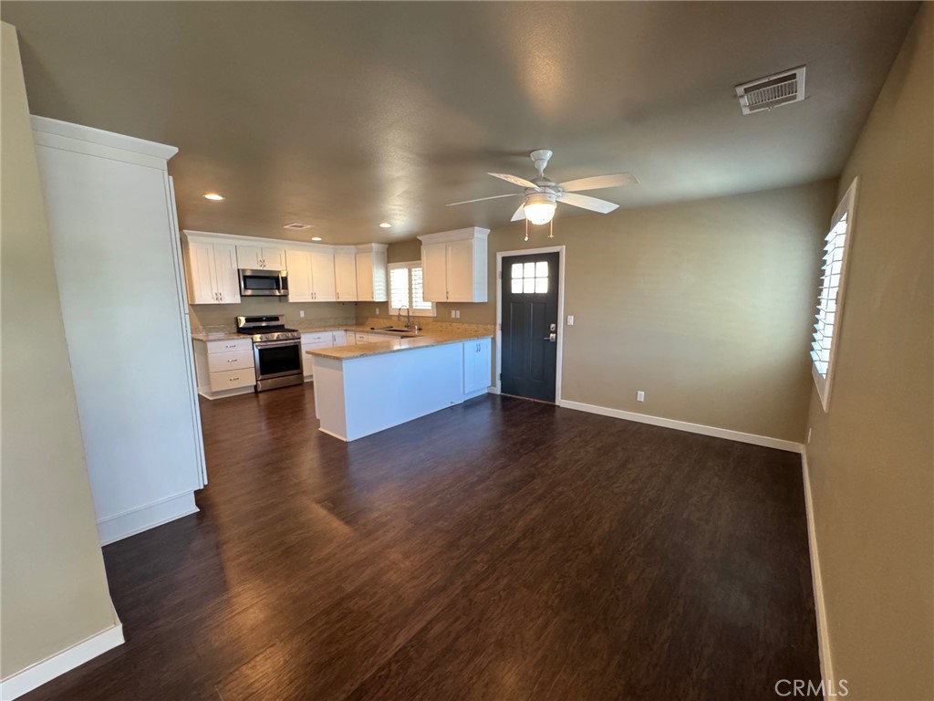 23843 Hayes Avenue, Unit ADU Murrieta, CA 92562 - Photo 4 of 24 a view of a kitchen with a sink a refrigerator and wooden floor