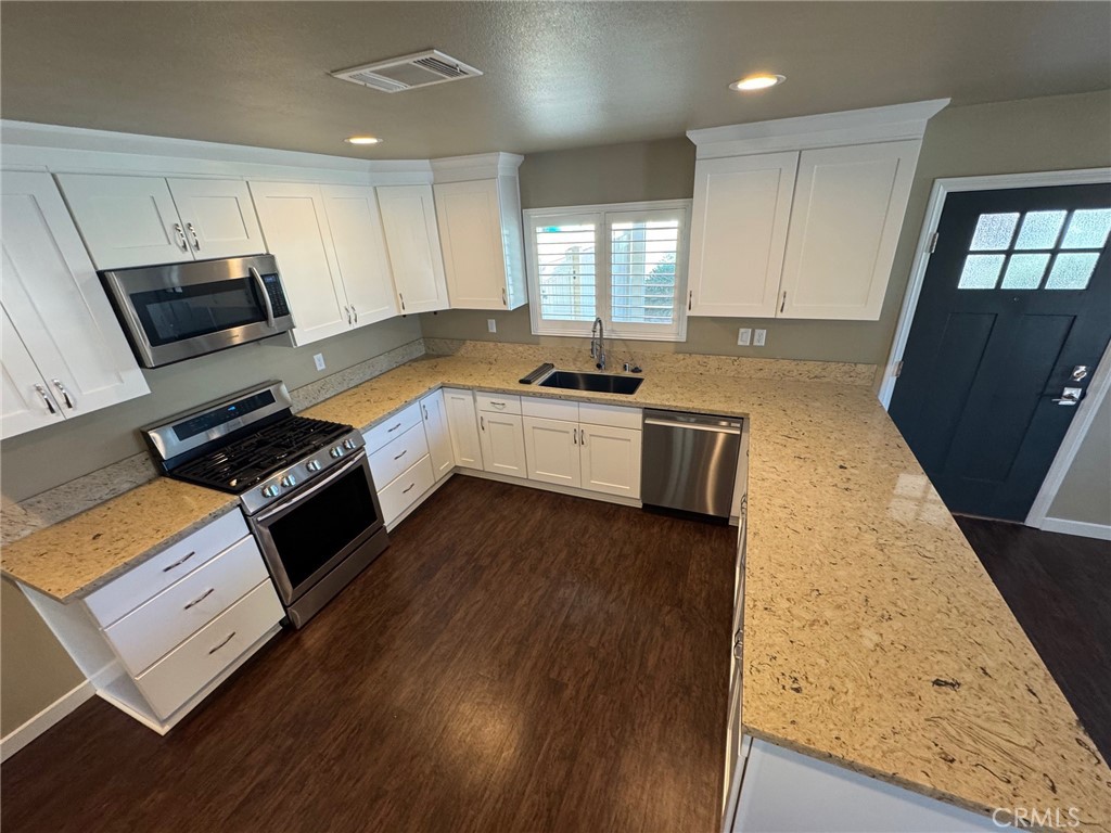23843 Hayes Avenue, Unit ADU Murrieta, CA 92562 - Photo 6 of 24 a large kitchen with stainless steel appliances granite countertop a stove a sink dishwasher and a microwave oven with wooden floor