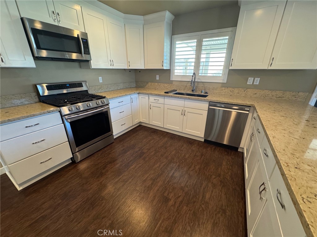 23843 Hayes Avenue, Unit ADU Murrieta, CA 92562 - Photo 7 of 24 a kitchen with a sink a microwave and cabinets