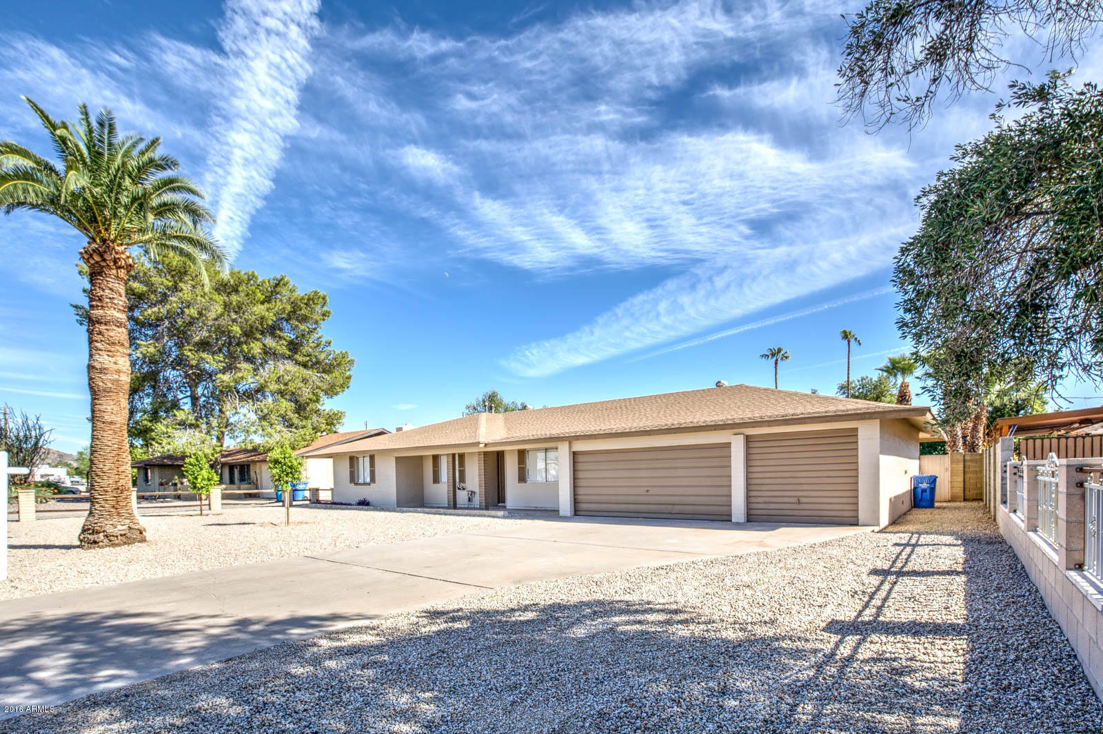3115 West Cactus Road Phoenix, AZ 85029 - Photo 3 of 30 a front view of a house with a yard and garage
