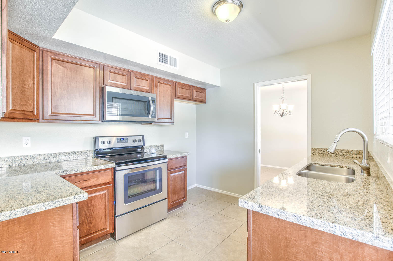 3115 West Cactus Road Phoenix, AZ 85029 - Photo 8 of 30 a kitchen with stainless steel appliances granite countertop a granite counter tops and a stove