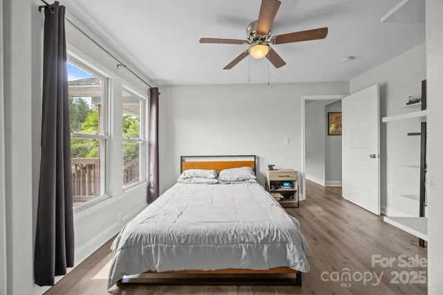 a bedroom with a large bed and a large window