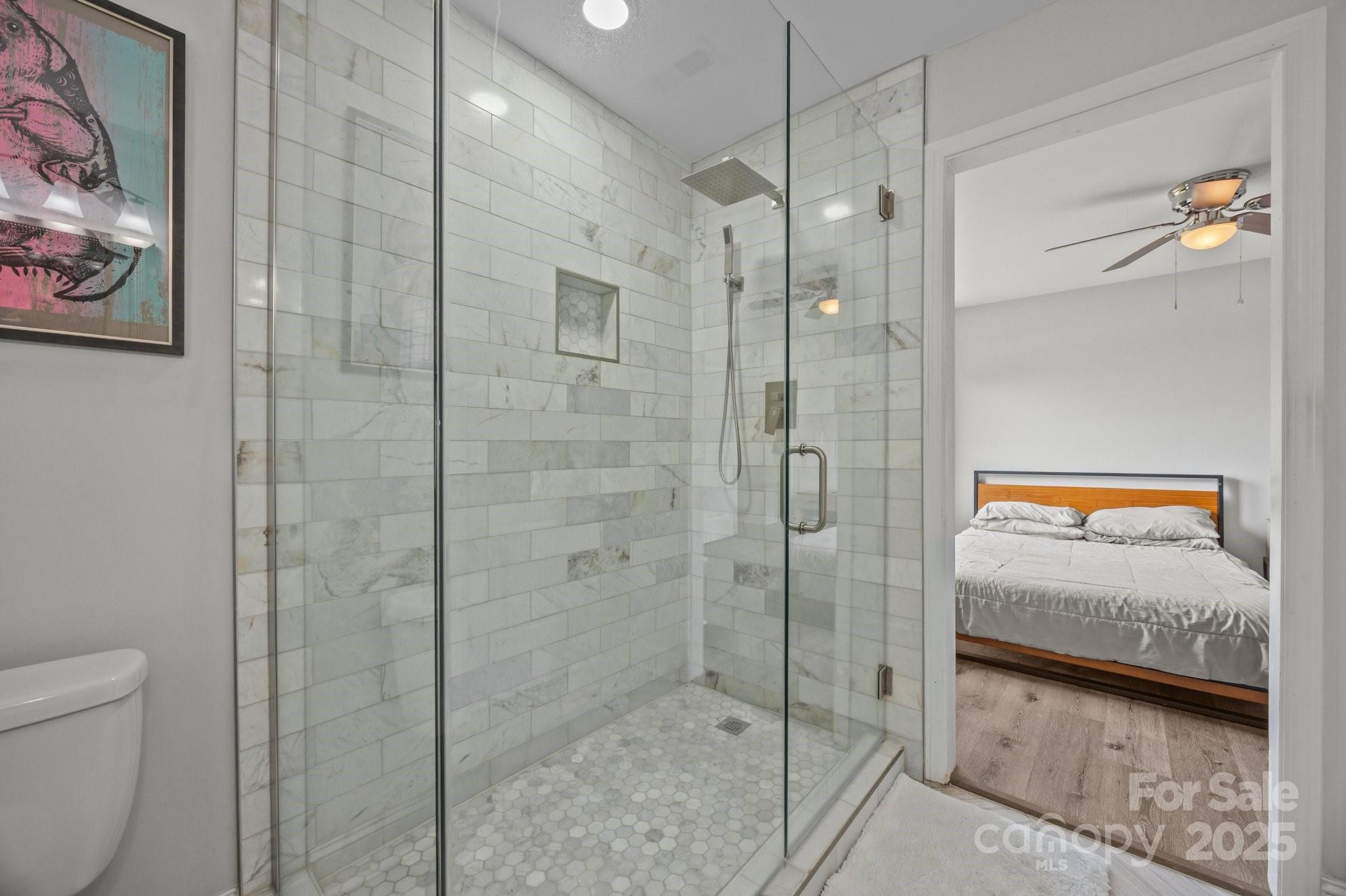 5371 Davidson Road Davidson, NC 28036 - Photo 16 of 27 a en suite bathroom with a granite countertop sink a toilet and shower