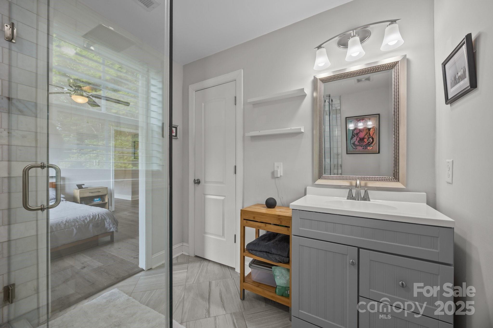 5371 Davidson Road Davidson, NC 28036 - Photo 17 of 27 a bathroom with a sink vanity and a mirror