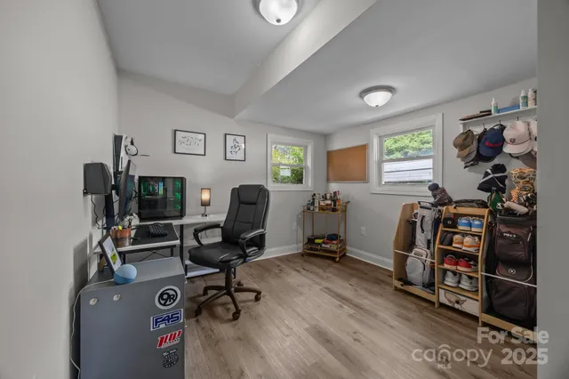 a view of a workspace with furniture and a window