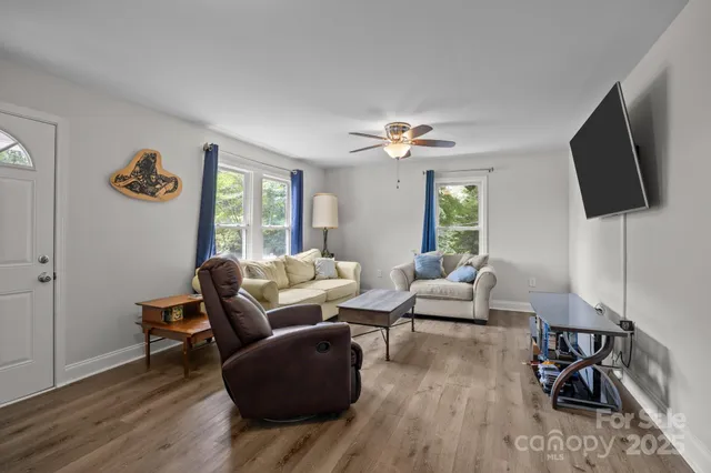 a living room with furniture and a flat screen tv