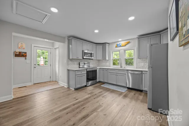 a kitchen with a white cabinets and window