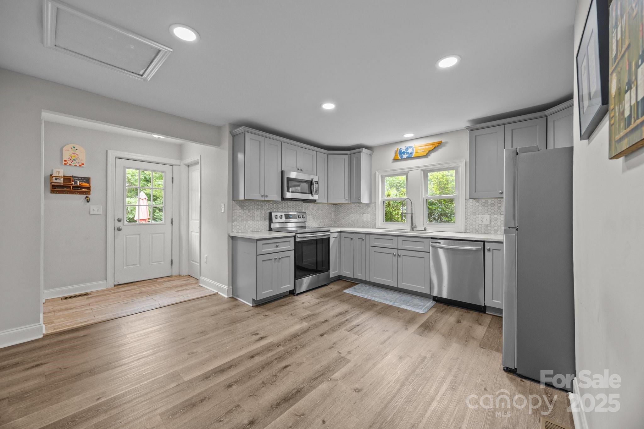 5371 Davidson Road Davidson, NC 28036 - Photo 5 of 27 a kitchen with a white cabinets and window