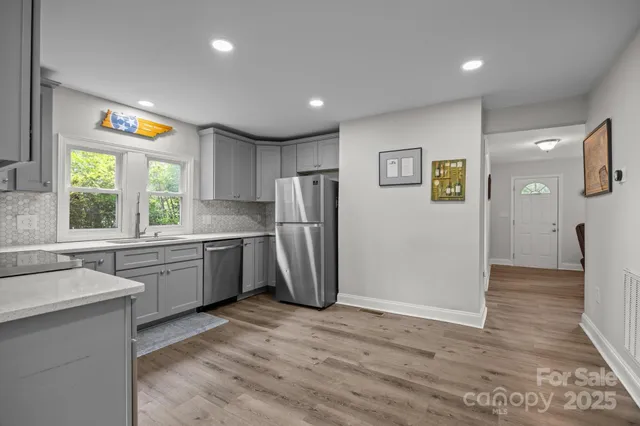 a kitchen with a refrigerator a sink and a stove