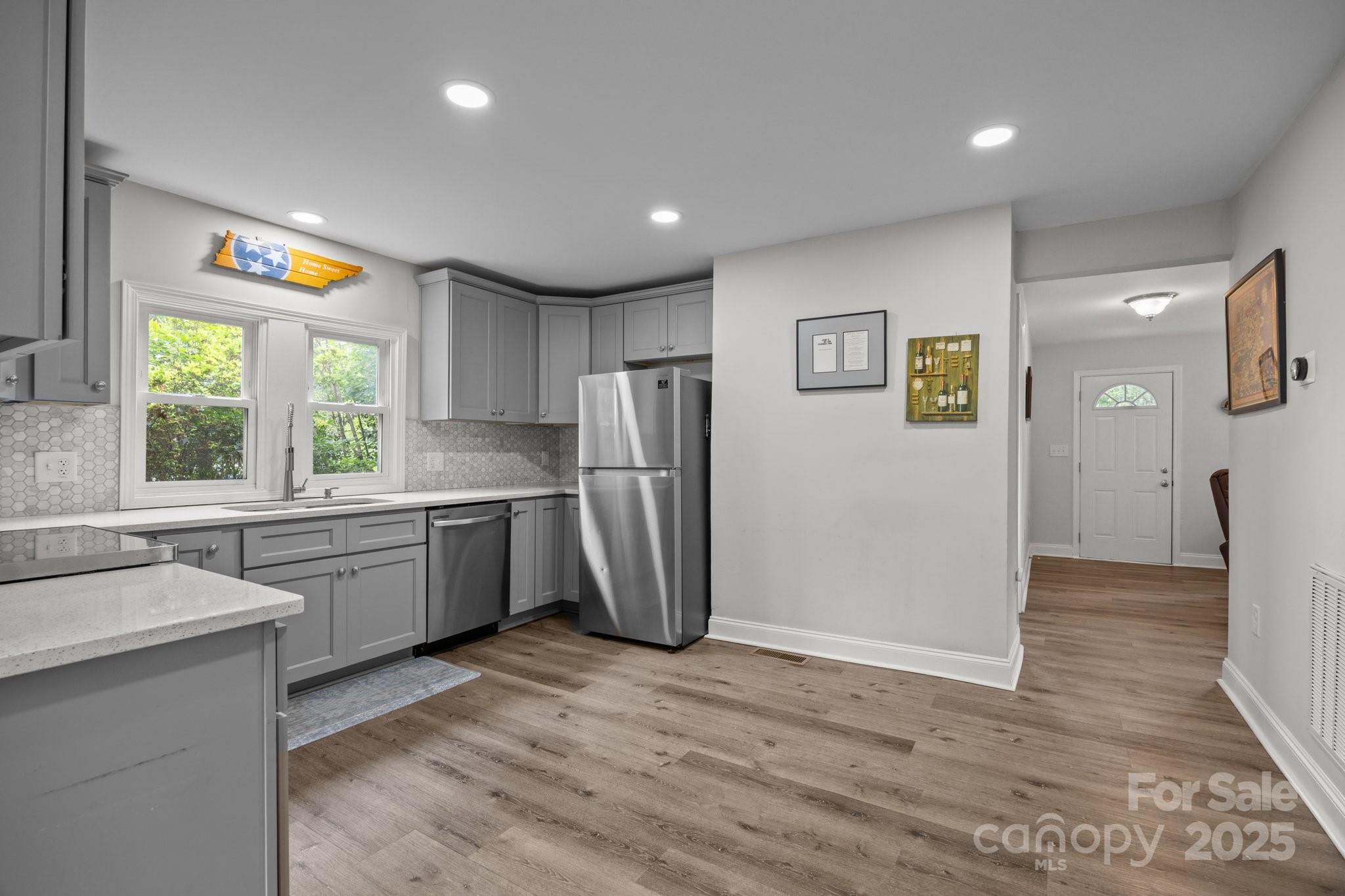 5371 Davidson Road Davidson, NC 28036 - Photo 7 of 27 a kitchen with a refrigerator a sink and a stove