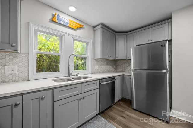 a kitchen with a refrigerator and a sink