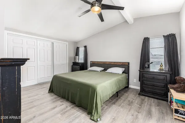 a bedroom with a bed and a mirror