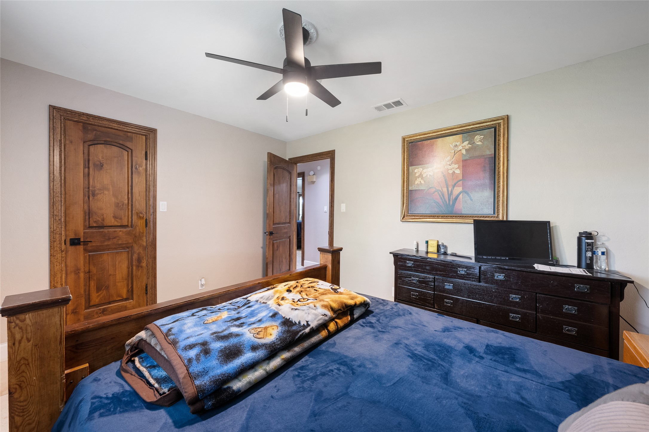 301 Oak Ridge Road Georgetown, TX 78628 - Photo 20 of 38 Interior room featuring light-toned walls and dark wood-finish doors with arched paneling