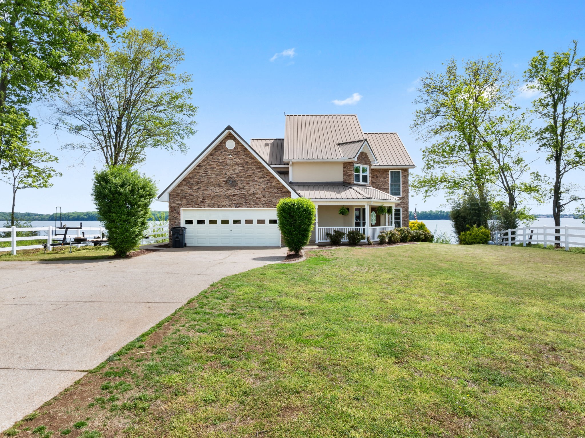 a view of a house with a yard and potted plants