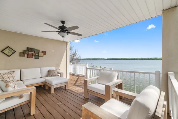 a kitchen with stainless steel appliances granite countertop a stove top oven a sink dishwasher and a refrigerator with wooden floor