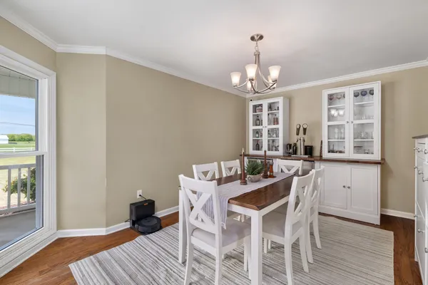 a kitchen with granite countertop white cabinets and stainless steel appliances