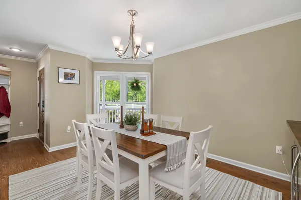 a view of a dining room with furniture and wooden floor
