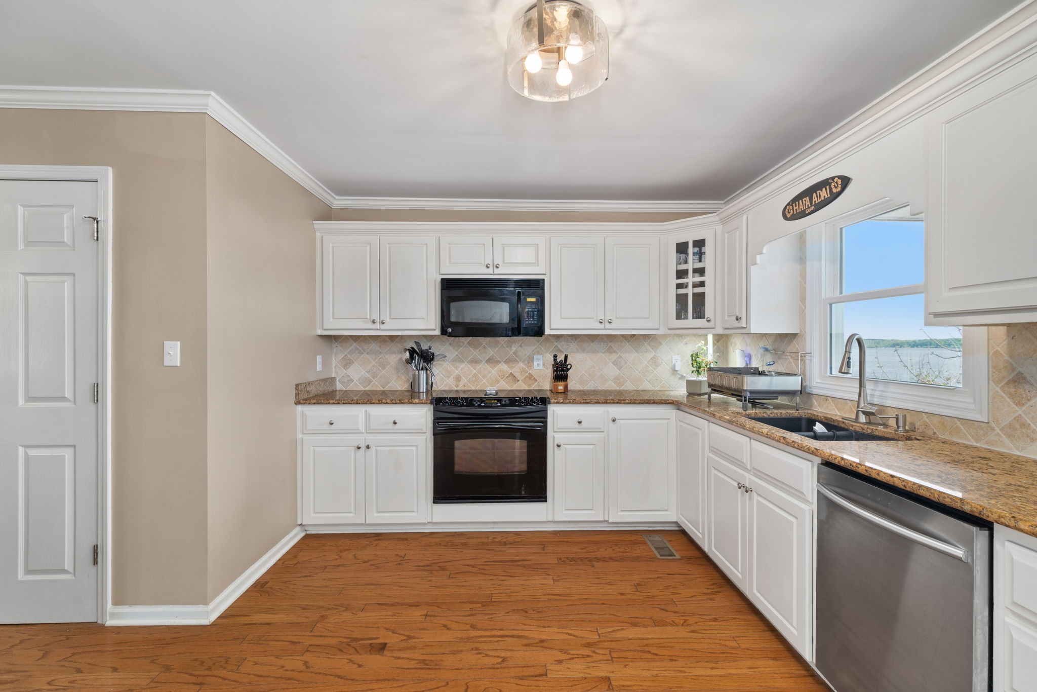 920 County Road 33 Killen, AL 35645 - Photo 17 of 80 a kitchen with stainless steel appliances granite countertop a stove top oven a sink dishwasher and a refrigerator with wooden floor