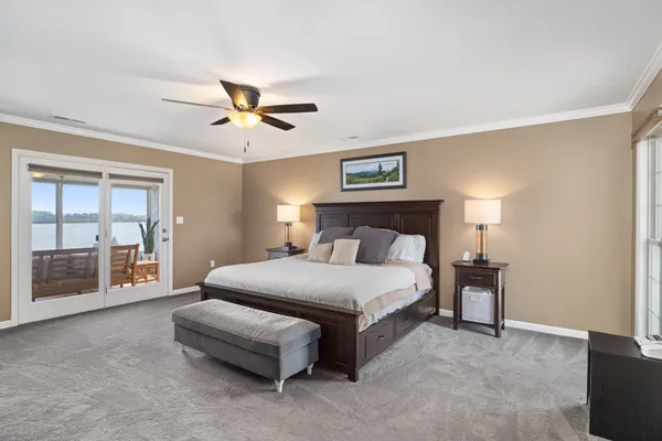 a spacious bedroom with a bed and a chandelier