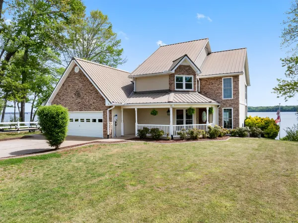 a view of a water with boats and trees in the background