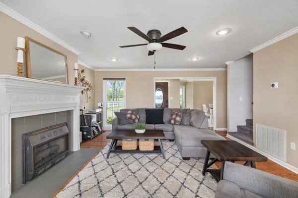 a living room with furniture and a ceiling fan
