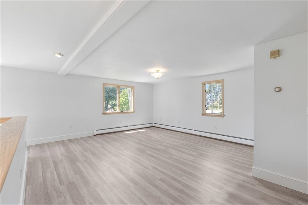 16 Crescent Avenue Beverly, MA 01915 - Photo 17 of 37 an empty room with wooden floor and windows