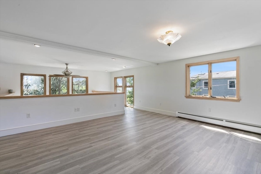 16 Crescent Avenue Beverly, MA 01915 - Photo 18 of 37 a view of an empty room with wooden floor and a window