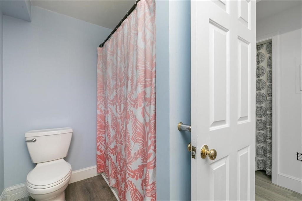 16 Crescent Avenue Beverly, MA 01915 - Photo 20 of 37 a bathroom with a toilet and shower curtain