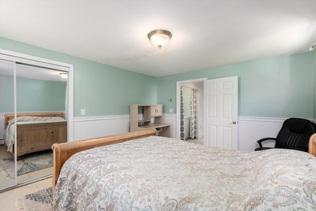 16 Crescent Avenue Beverly, MA 01915 - Photo 22 of 37 a bedroom with a bed and a mirror