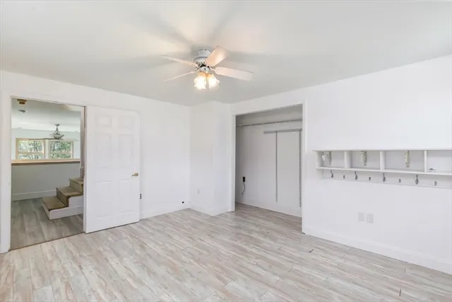 a view of livingroom with hardwood floor and a ceiling fan