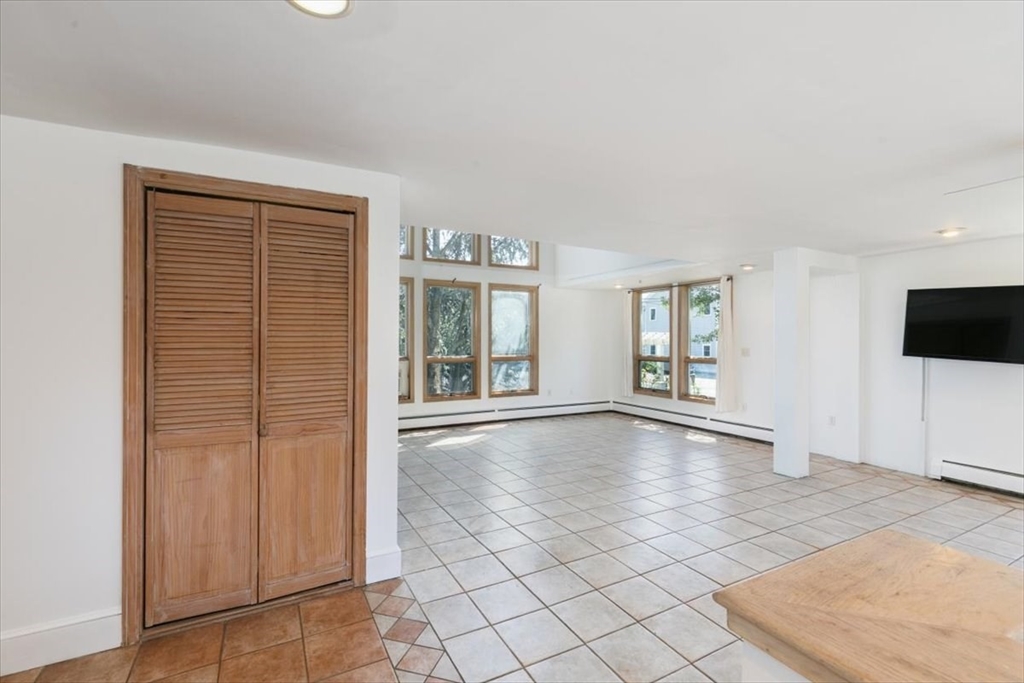 16 Crescent Avenue Beverly, MA 01915 - Photo 4 of 37 a view of an empty room with window and wooden floor