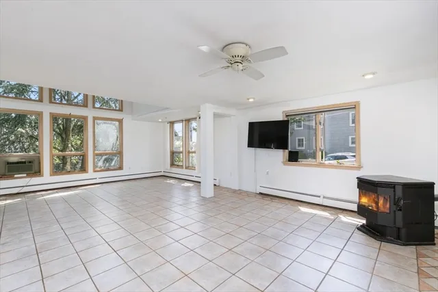 a view of an empty room with window and cabinet